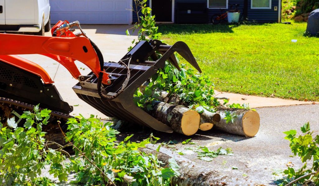 Building demolition contractor in Parrish FL clearing trees and debris with excavator during residential site preparation
