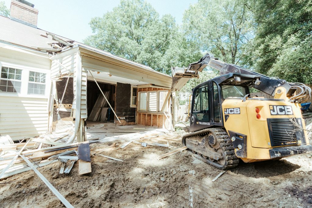 JCB skid steer demolishing residential structure during excavation and site preparation project in Parrish FL