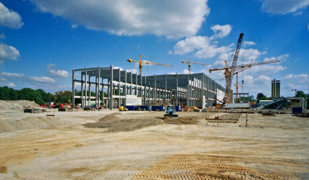 Large-scale commercial construction site prep in Bradenton with graded building pad crane activity and active site preparation work underway in Manatee County