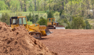 Two bulldozers grading a cleared parcel during a land clearing project in Sarasota County Florida