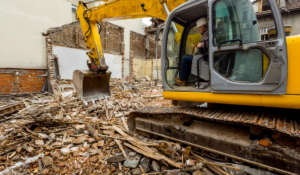 Excavator operator sorting demolition debris during a residential demolition project in Parrish Florida